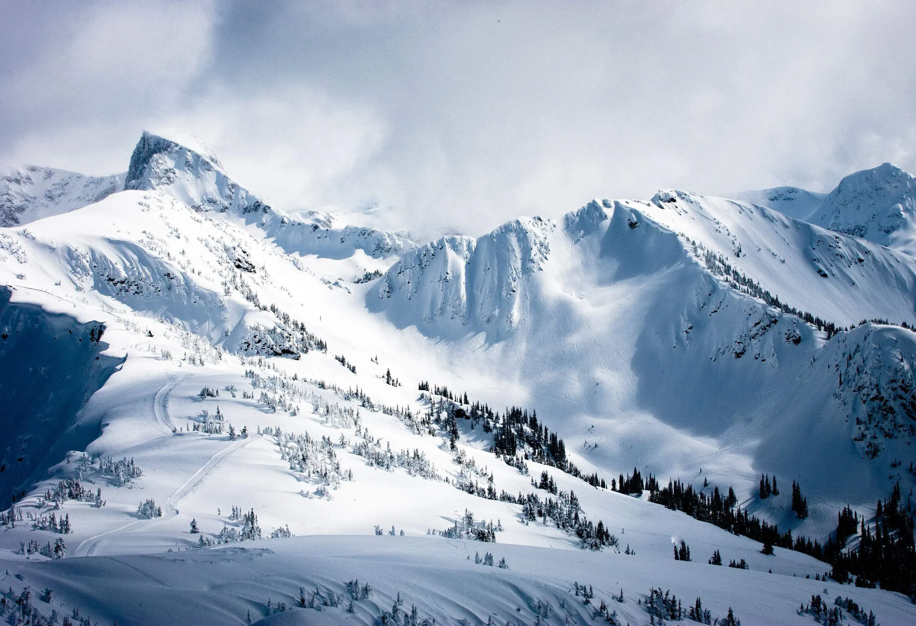 Steep rocky mountains covered with deep snow create diverse ski areas.