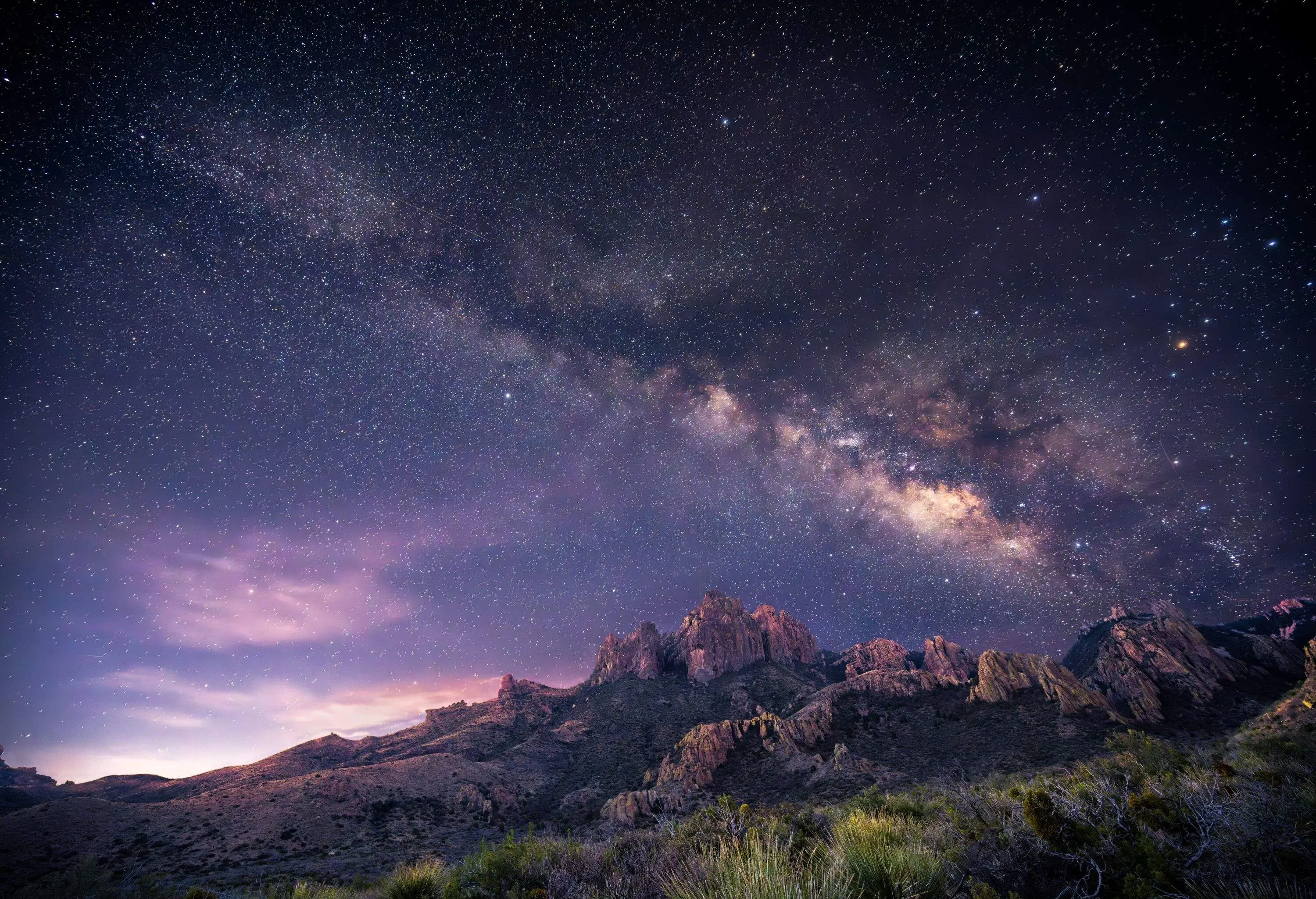 Desert rocky mountain range under the night sky
