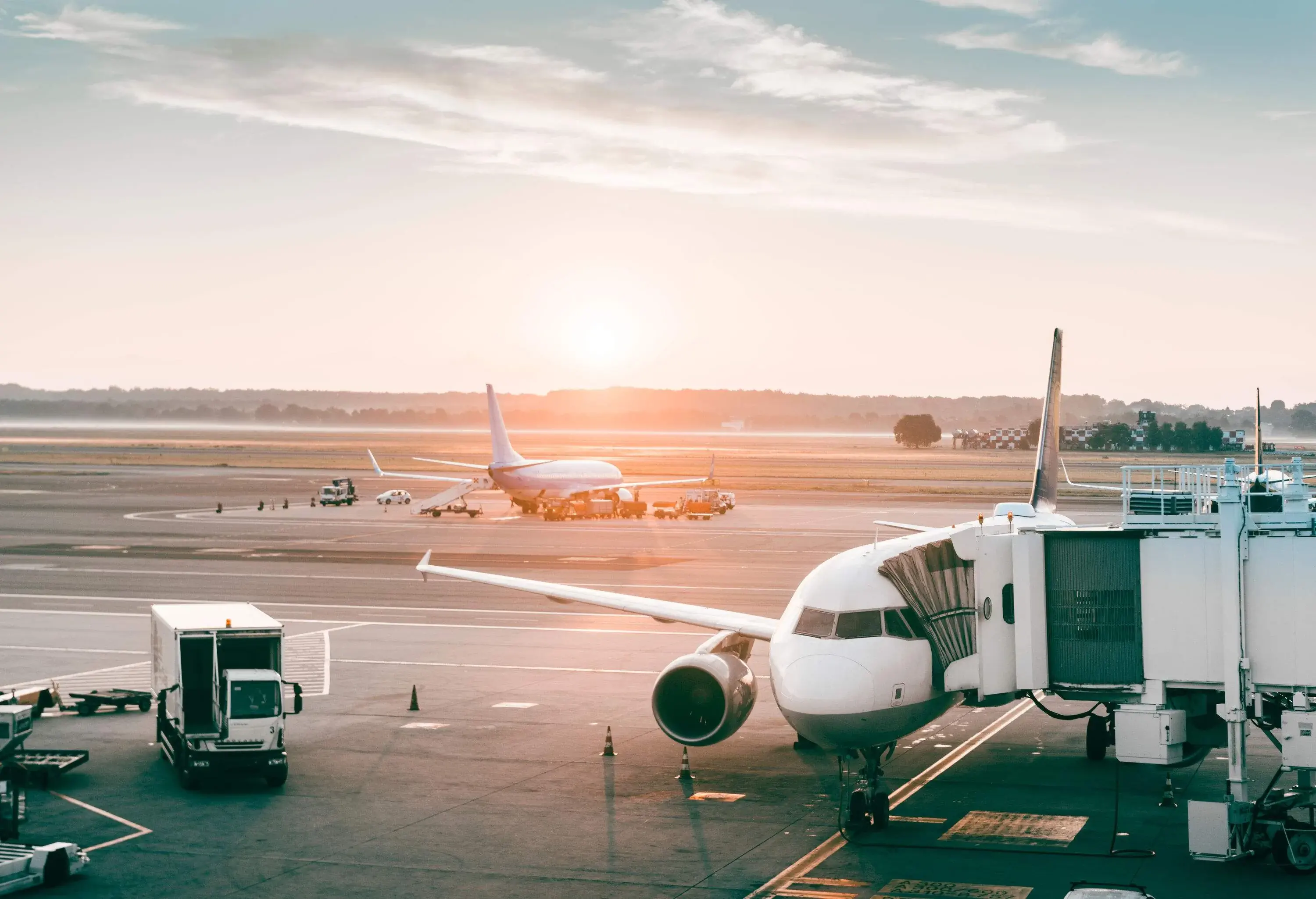 The sun shines through a bustling airport.