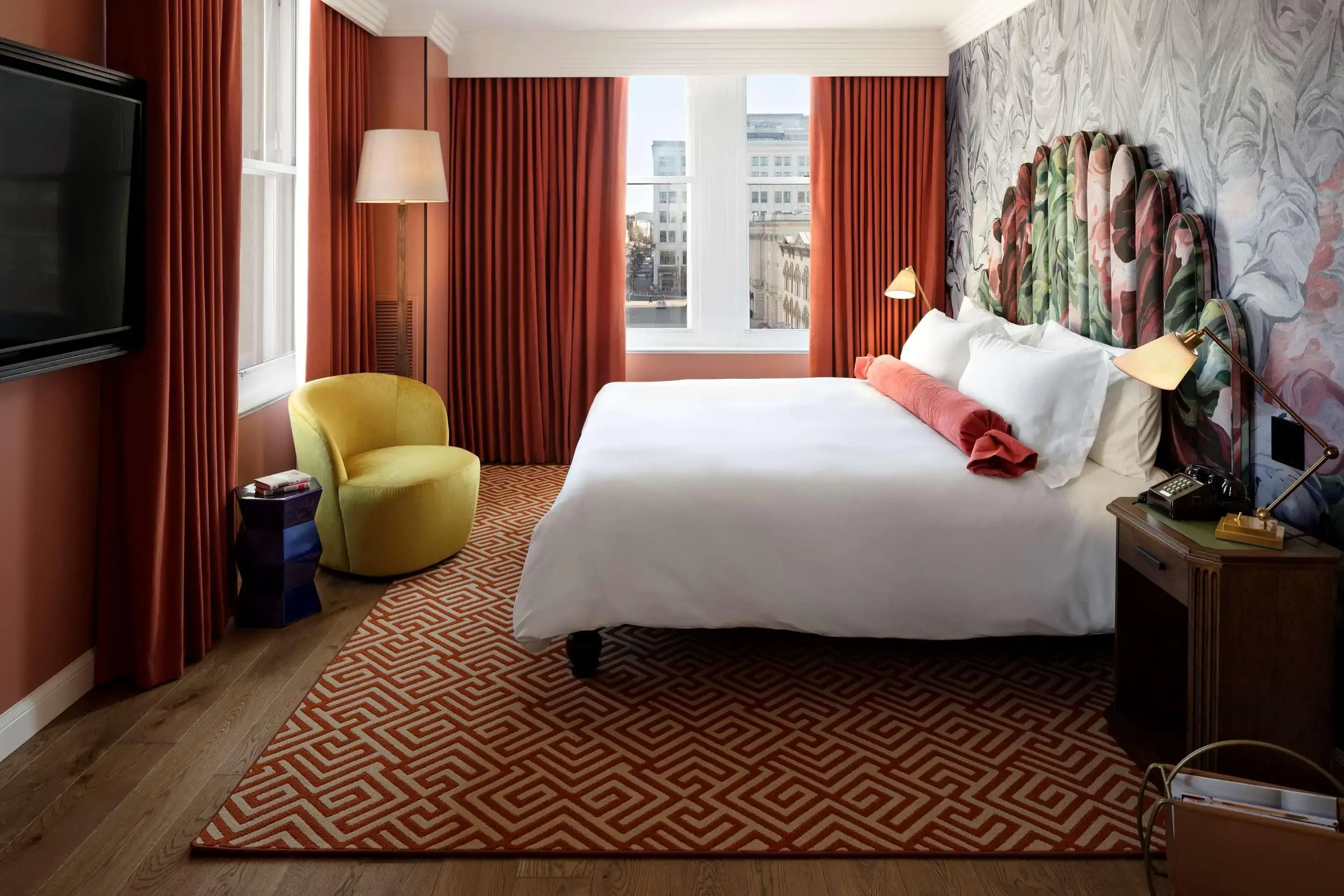 Interior view of eclectic hotel room in earthy tones and plush velvet soft furnishings