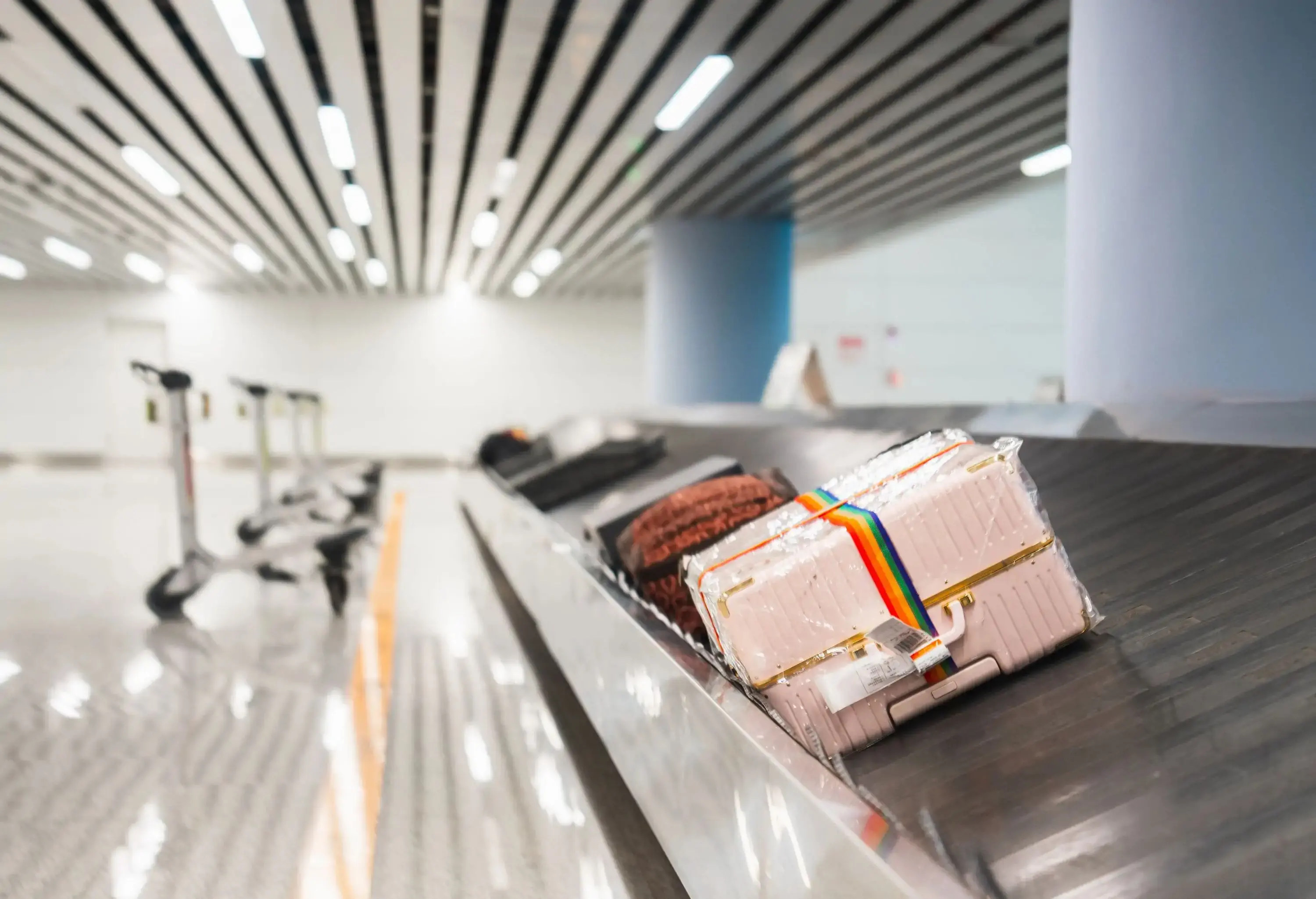 a couple of luggages on a luggage reclaim
