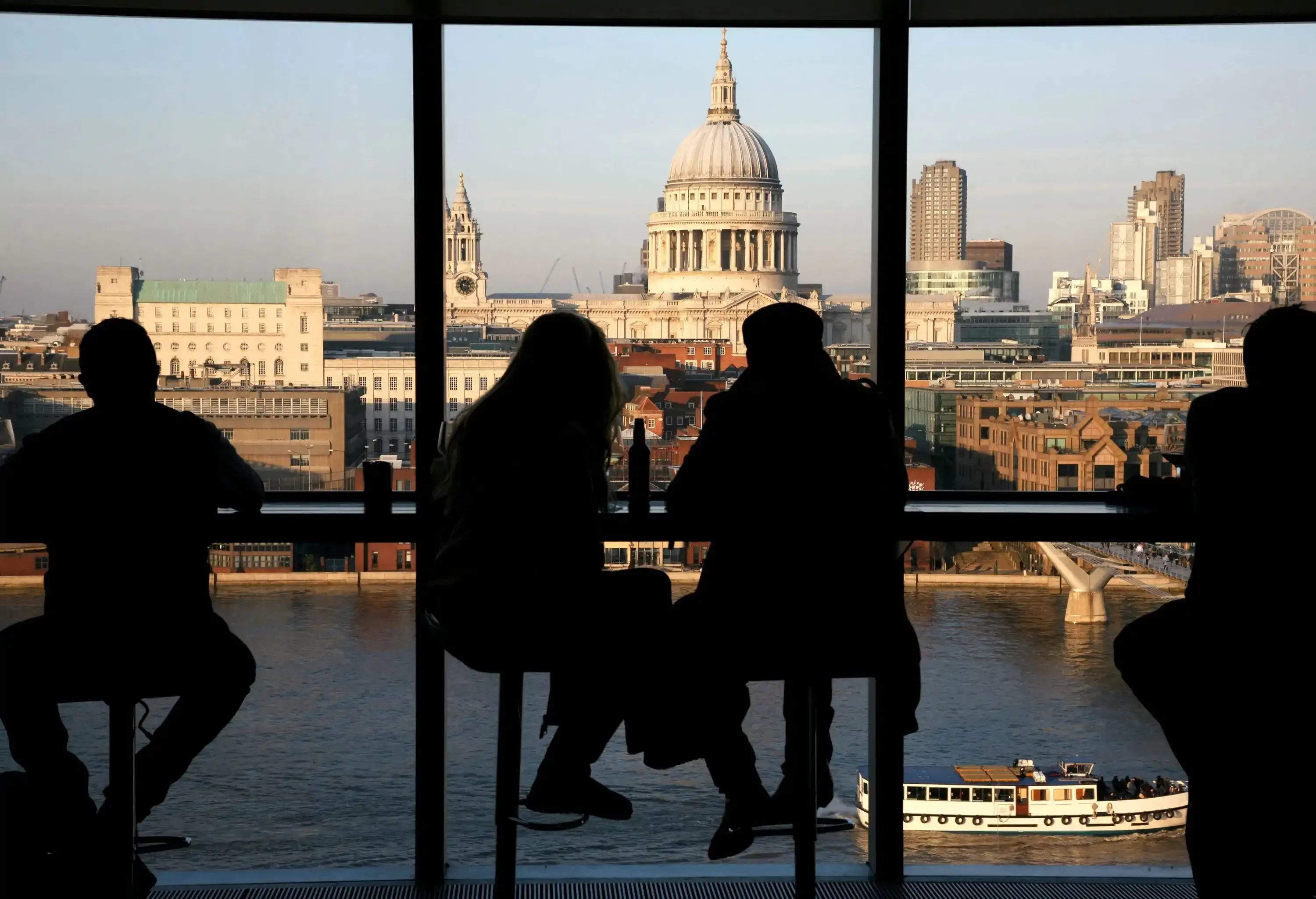 A couple tourists over looking St Paul's Cathedral from Tate Modern