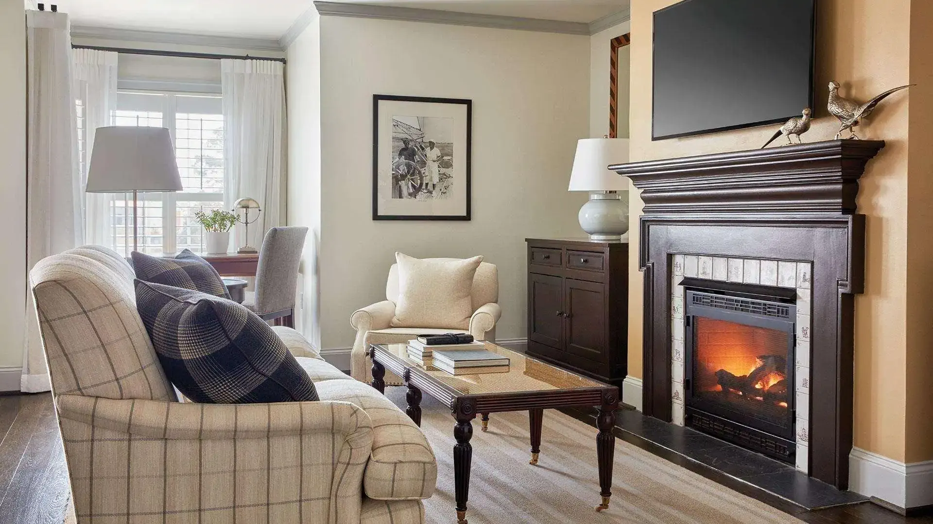 Cozy hotel room in neutral colours with a lit fireplace