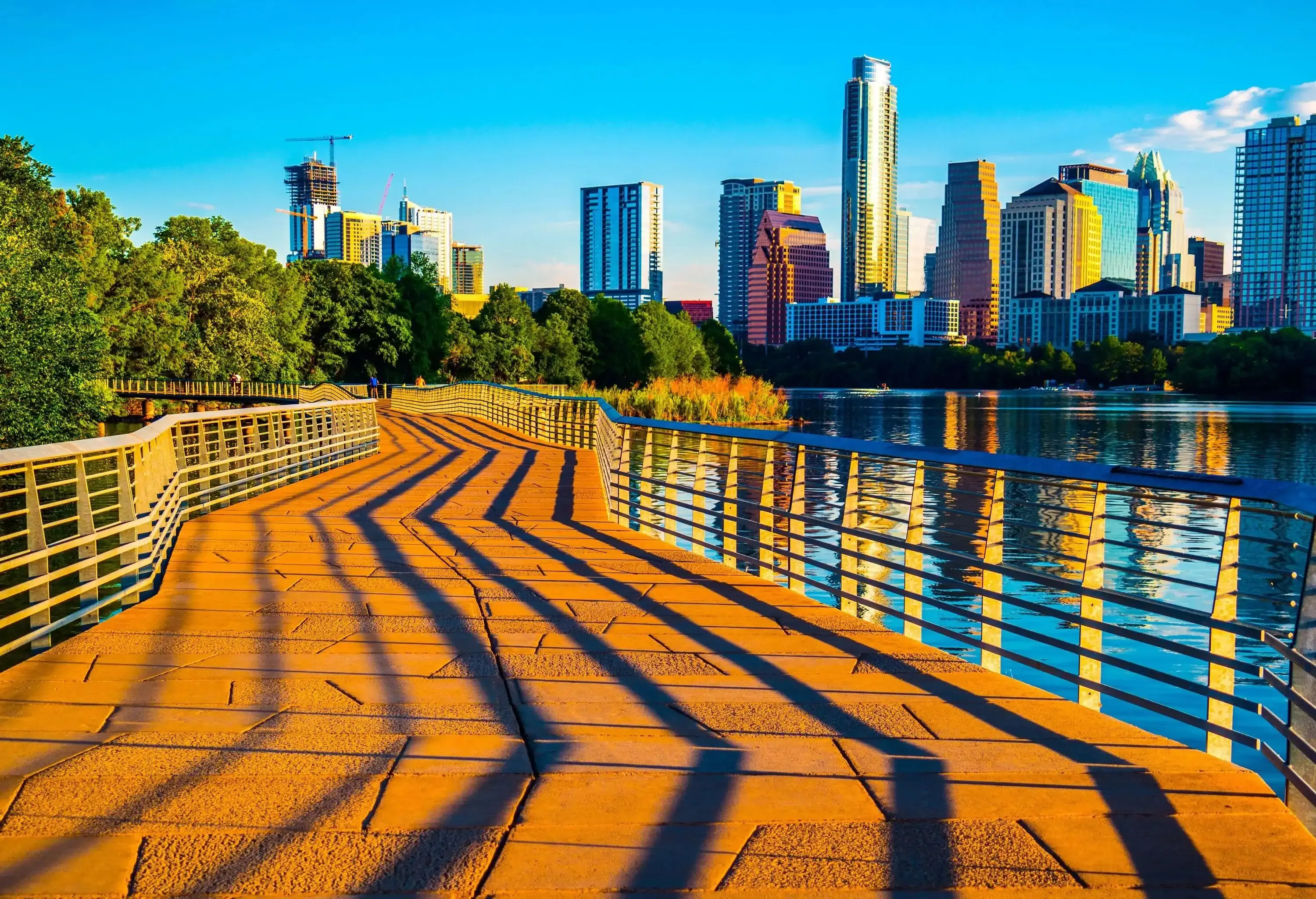 Austin Texas Abstract Skyline Cityscape as the sunrise hits the riverside pedestrian bridge modern architecture creates an amazing display of shadows across the bridge leading up to the skyline downtown