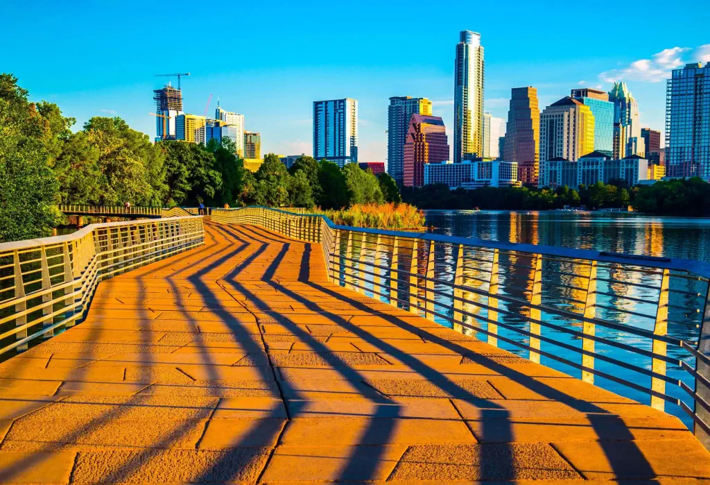 Austin Texas Abstract Skyline Cityscape as the sunrise hits the riverside pedestrian bridge modern architecture creates an amazing display of shadows across the bridge leading up to the skyline downtown