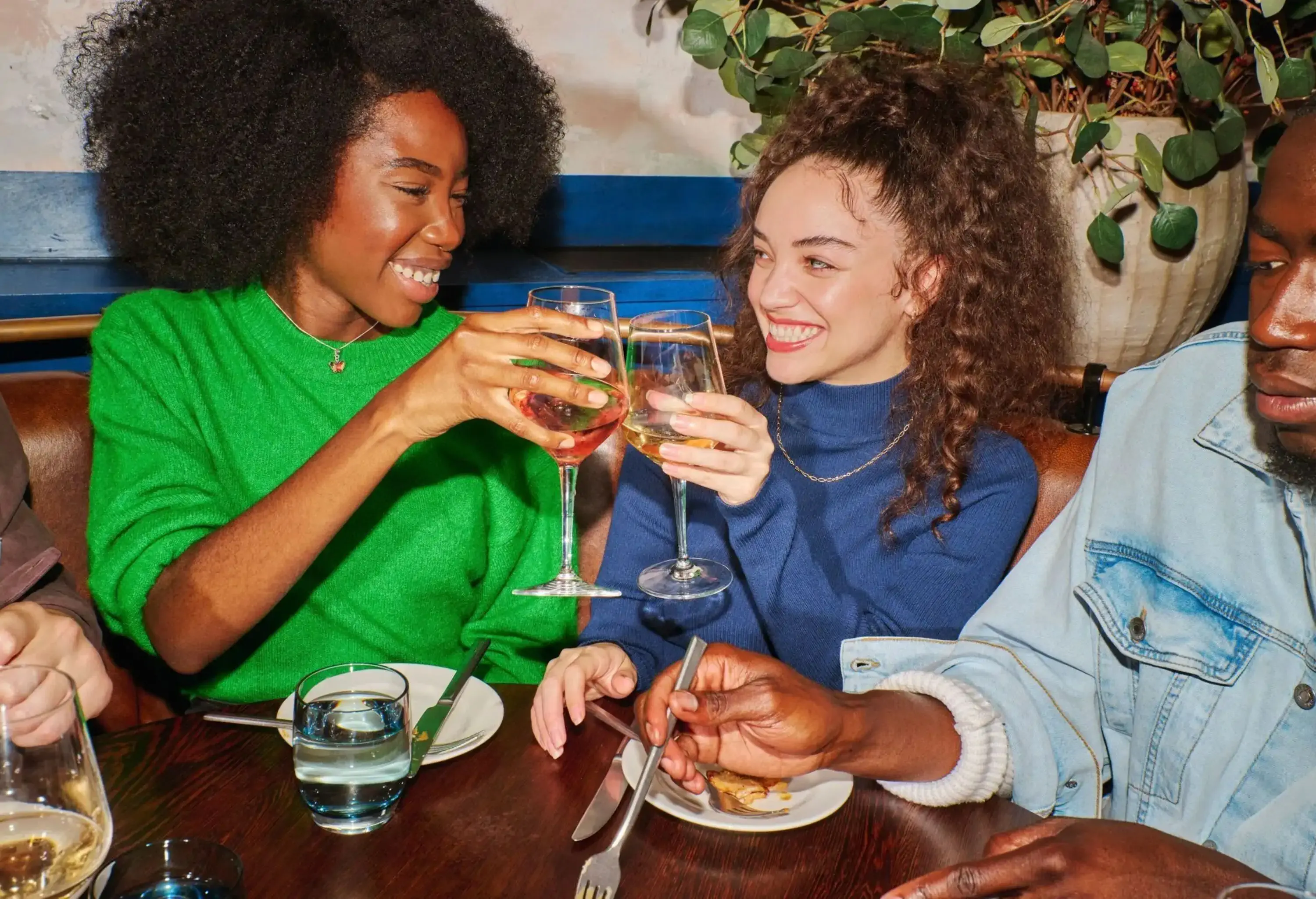 Two friends raising their wine glasses for a toast.
