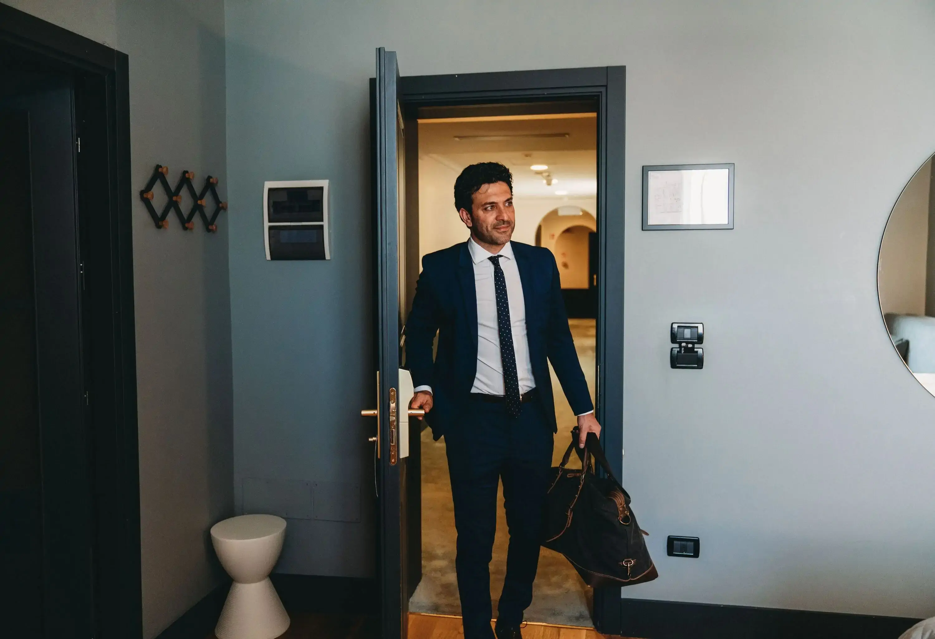 A businessman is entering in an hotel room. View from inside the room.