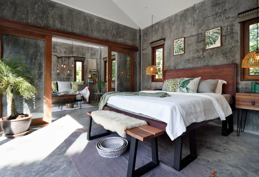 The bedroom features unpainted walls adorned with a nature motif, bringing a touch of the outdoors inside.