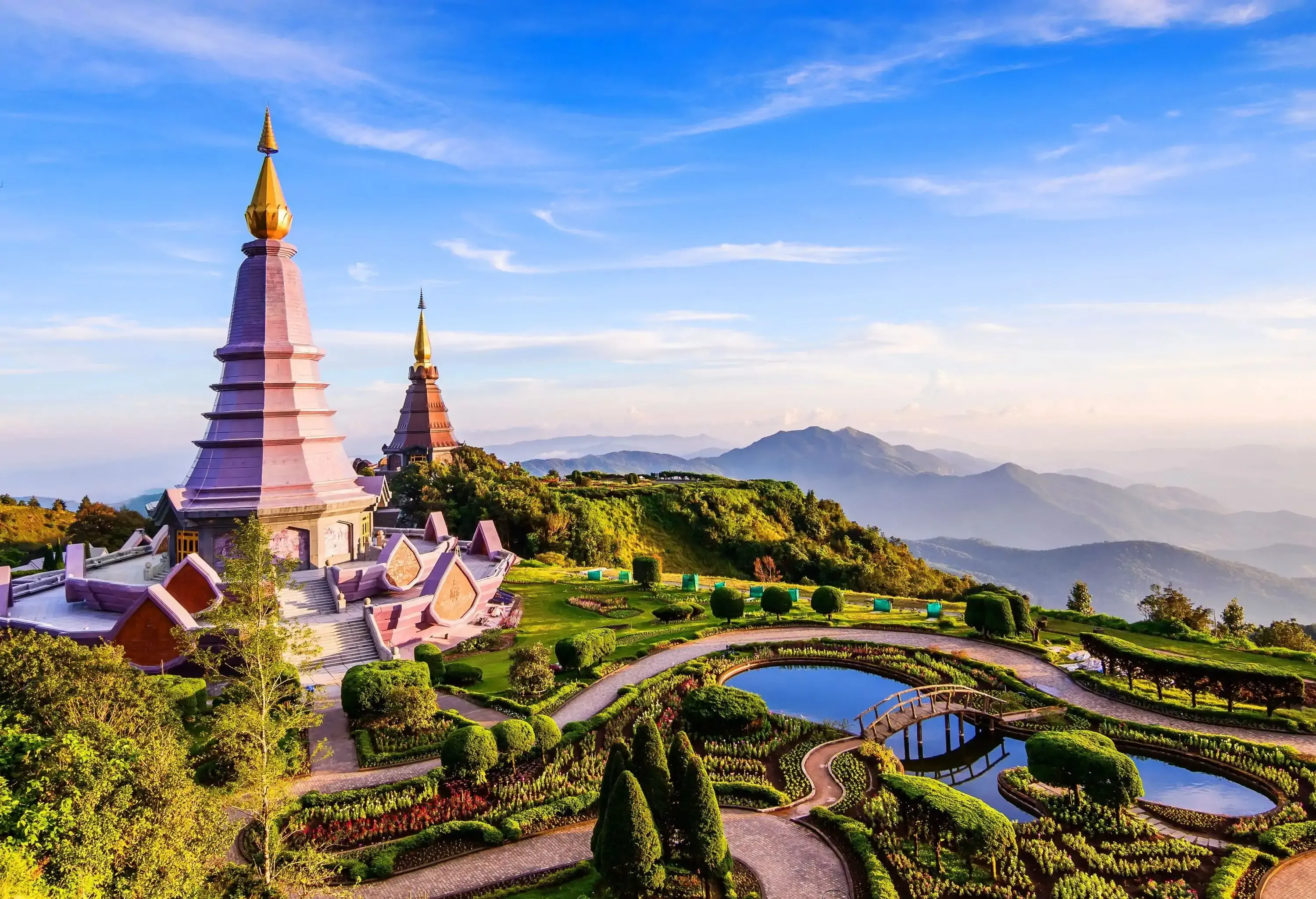 A scenic landscape on a lush mountaintop with protruding twin pagodas.