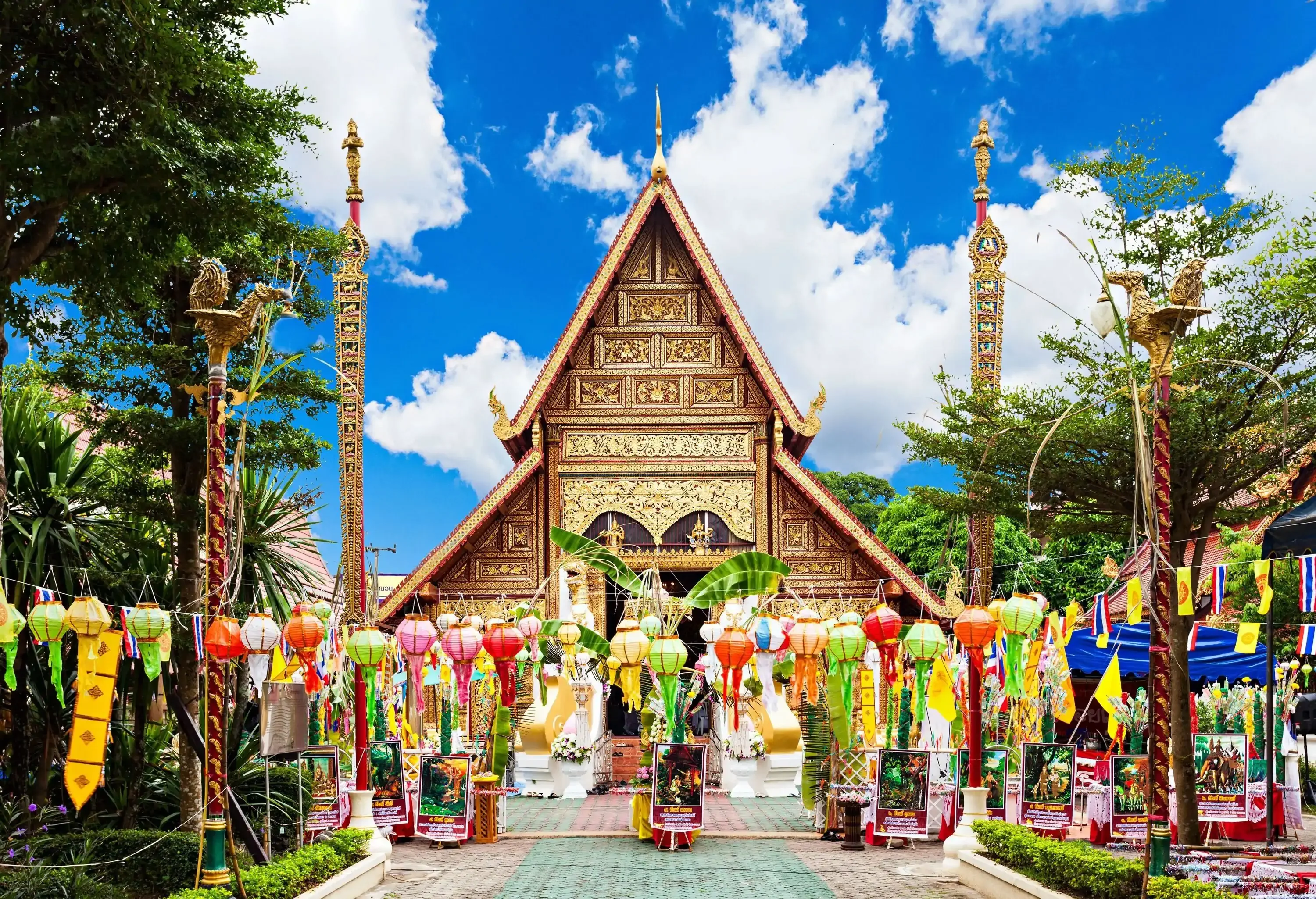The entrance of a beautiful Buddhist temple is decorated with colourful lanterns.