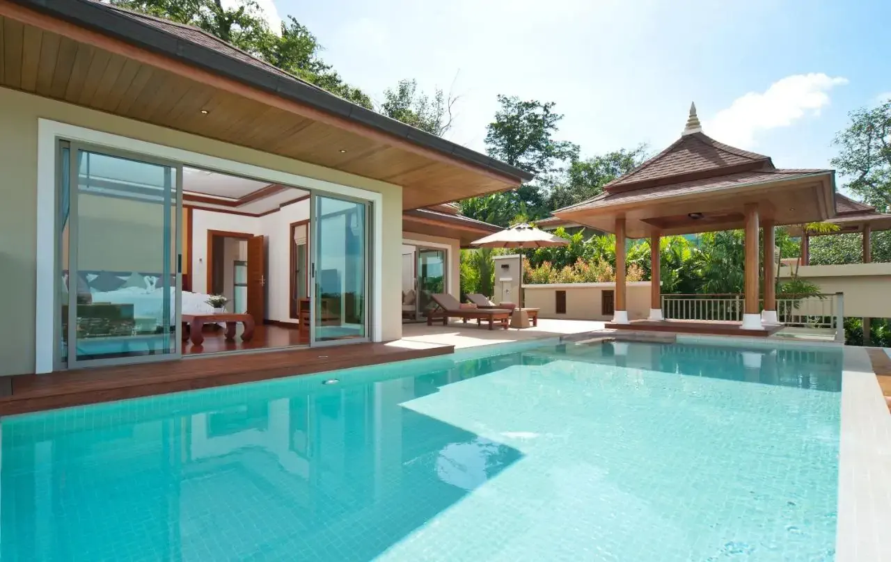 A hotel villa with a pool by a luxury suite in a tropical setting