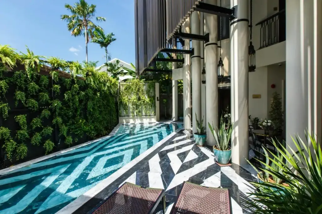 Modern building with exterior pool with black and white diamond pattern
