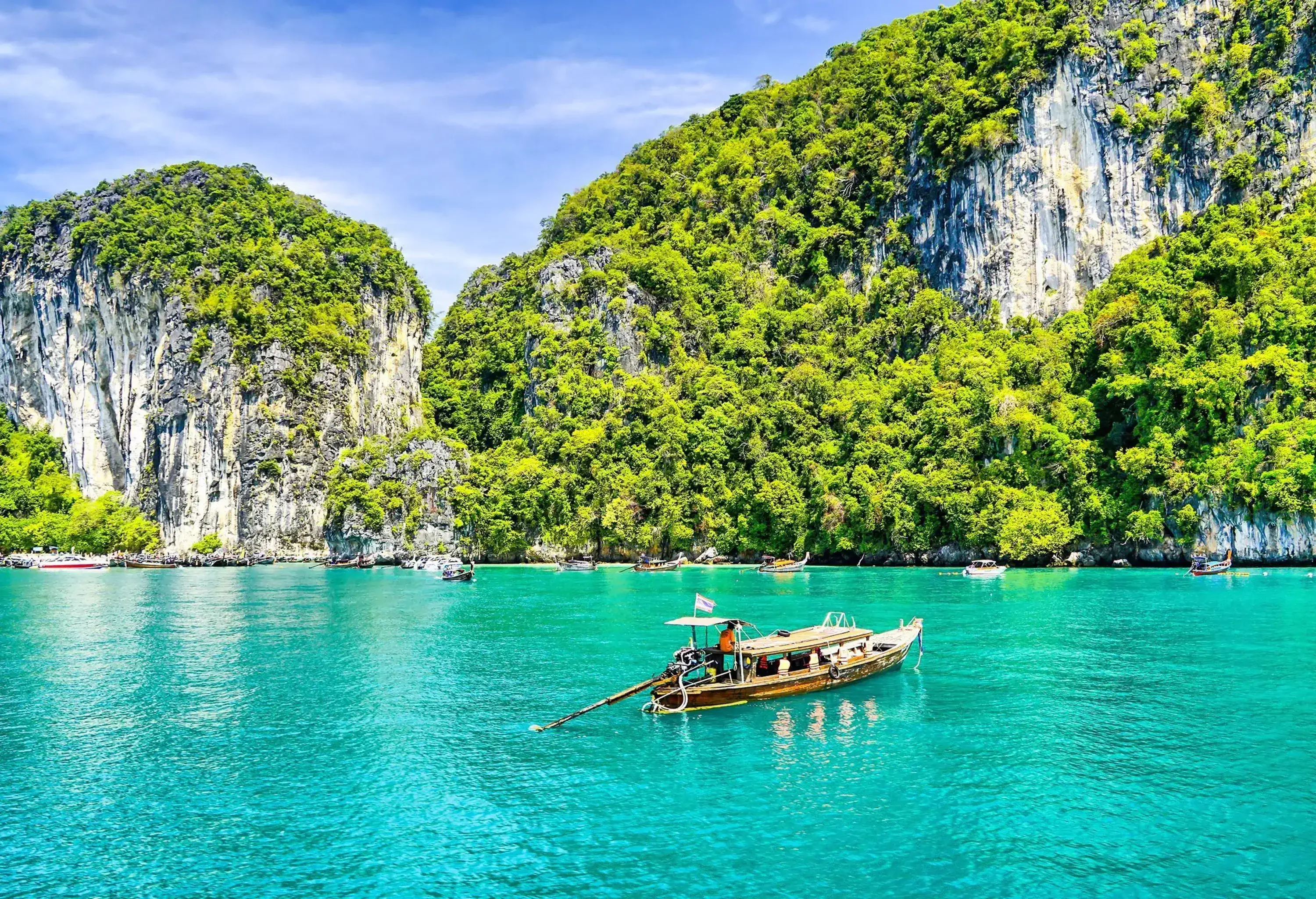 A boat gracefully navigates through a scenic landscape of towering rock formations.