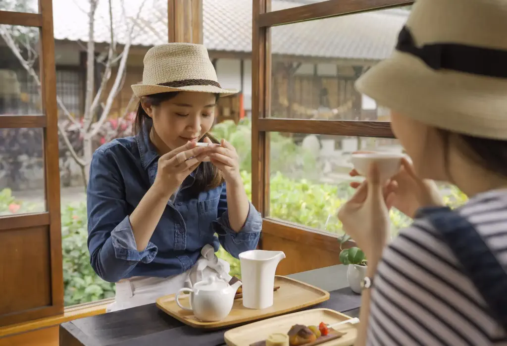 Two young women enjoy tea at a local Japanese cafe.