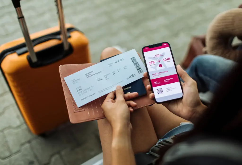 Close-up of the passport, phone, and ticket, with a bag in the distance