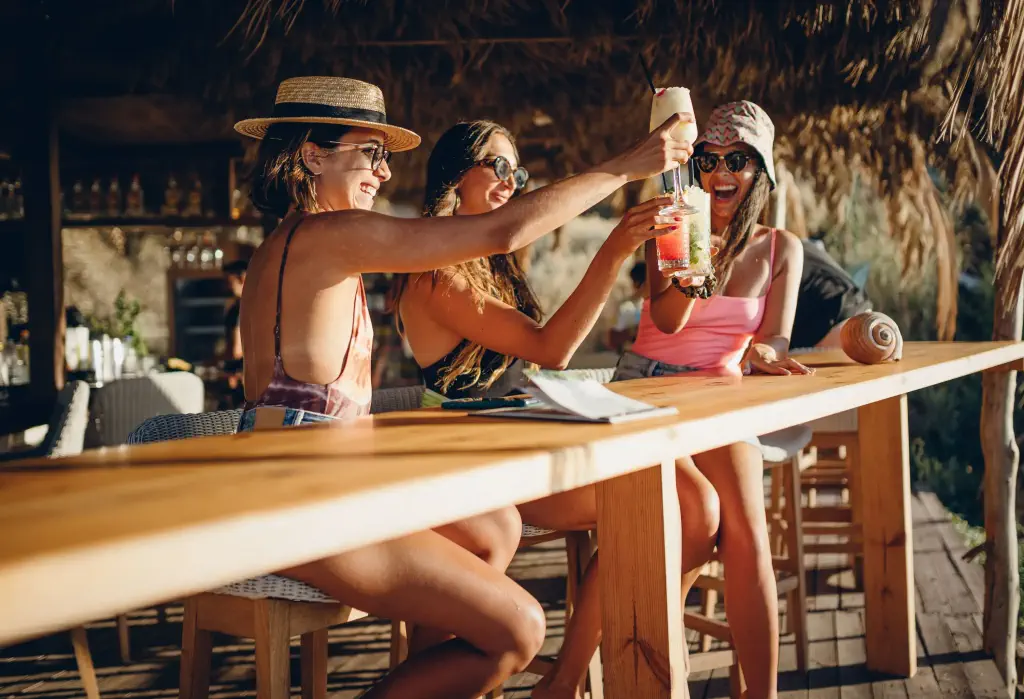 Three friends in a summer beach bar