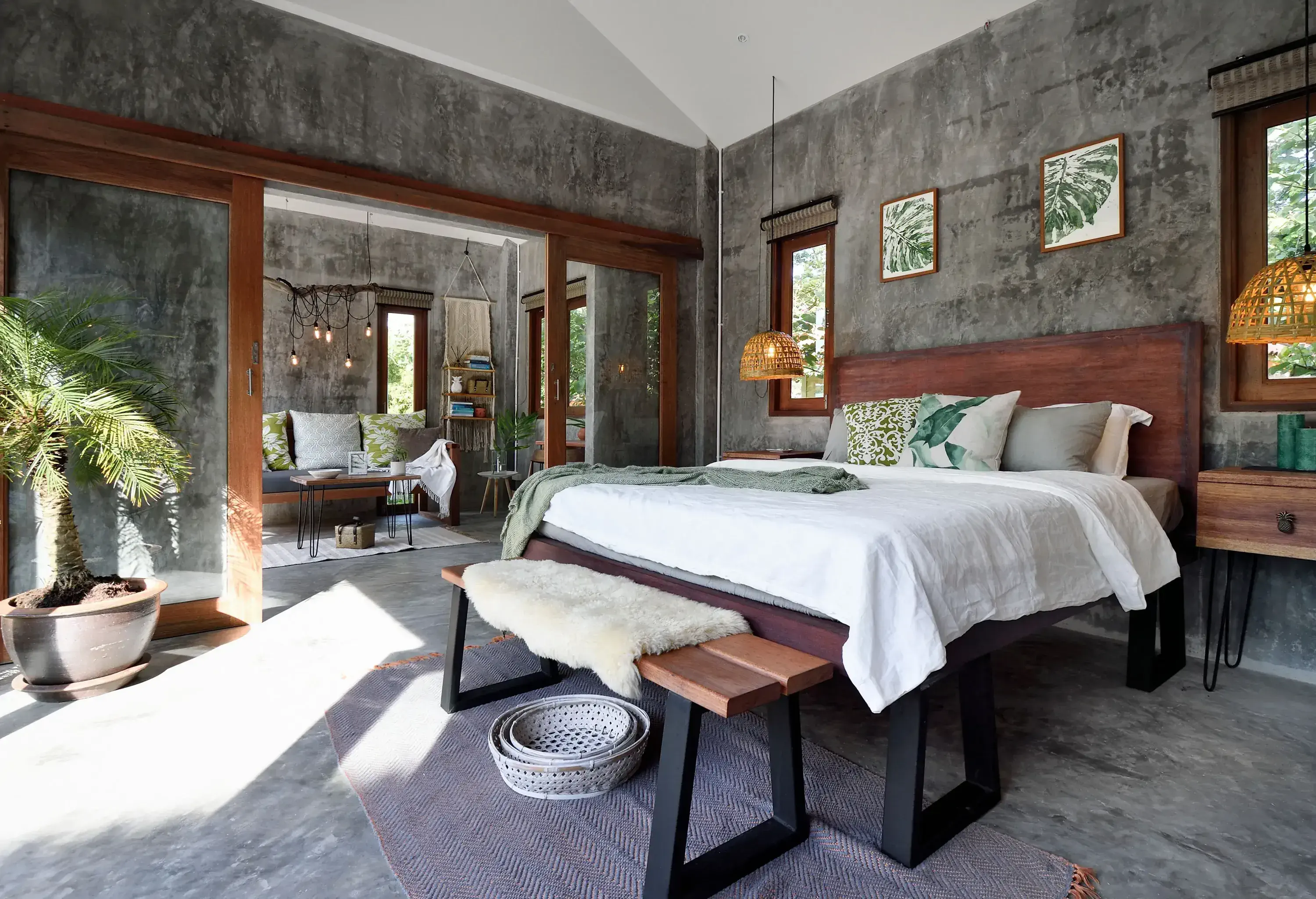 The bedroom features unpainted walls adorned with a nature motif, bringing a touch of the outdoors inside.
