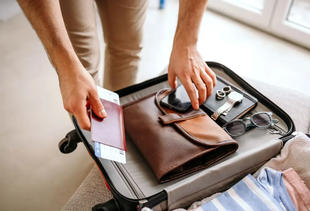 Man is packing a suitcase to go on a trip/business trip.