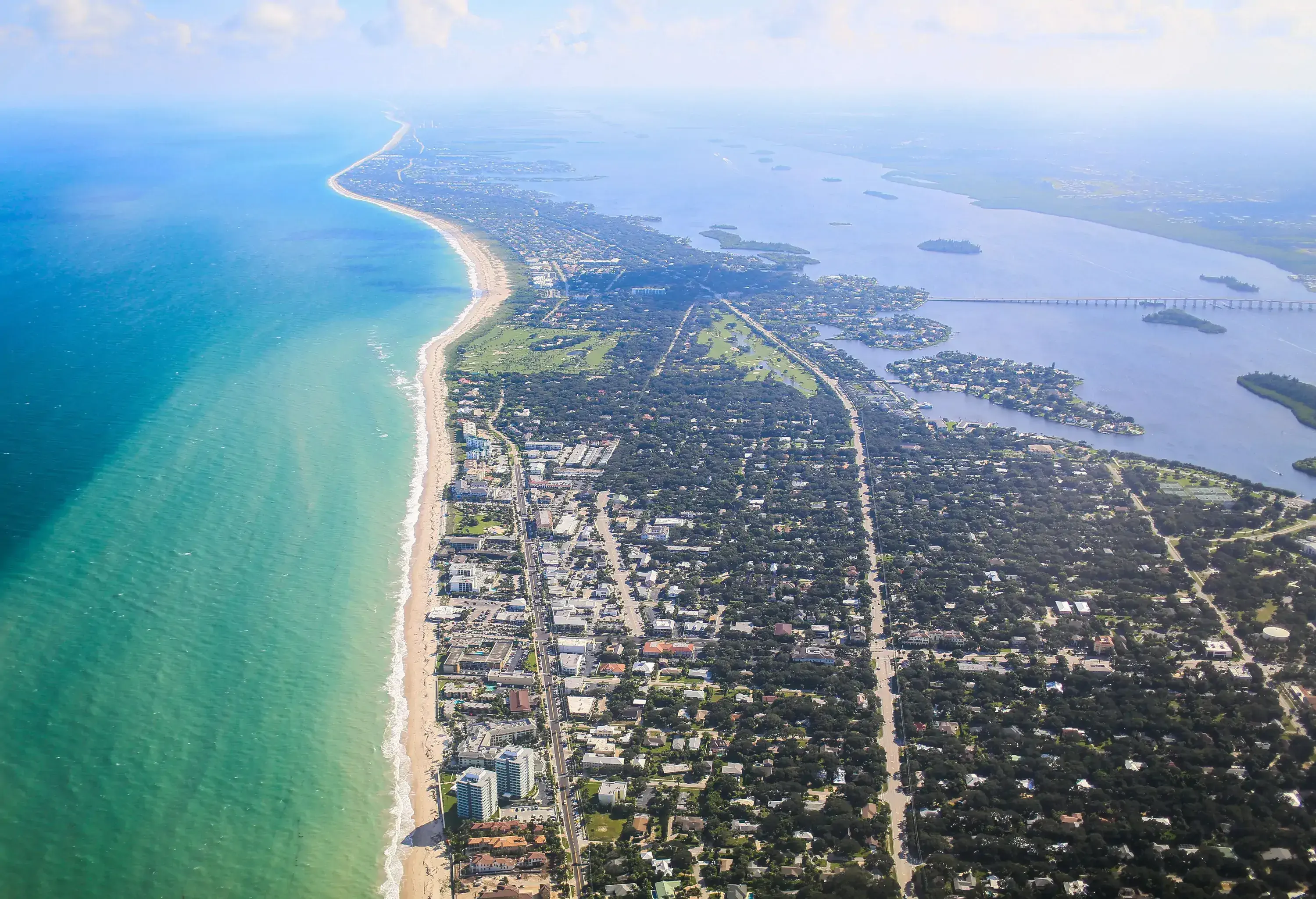 Urban landscape of coastal city beside a vast ocean.