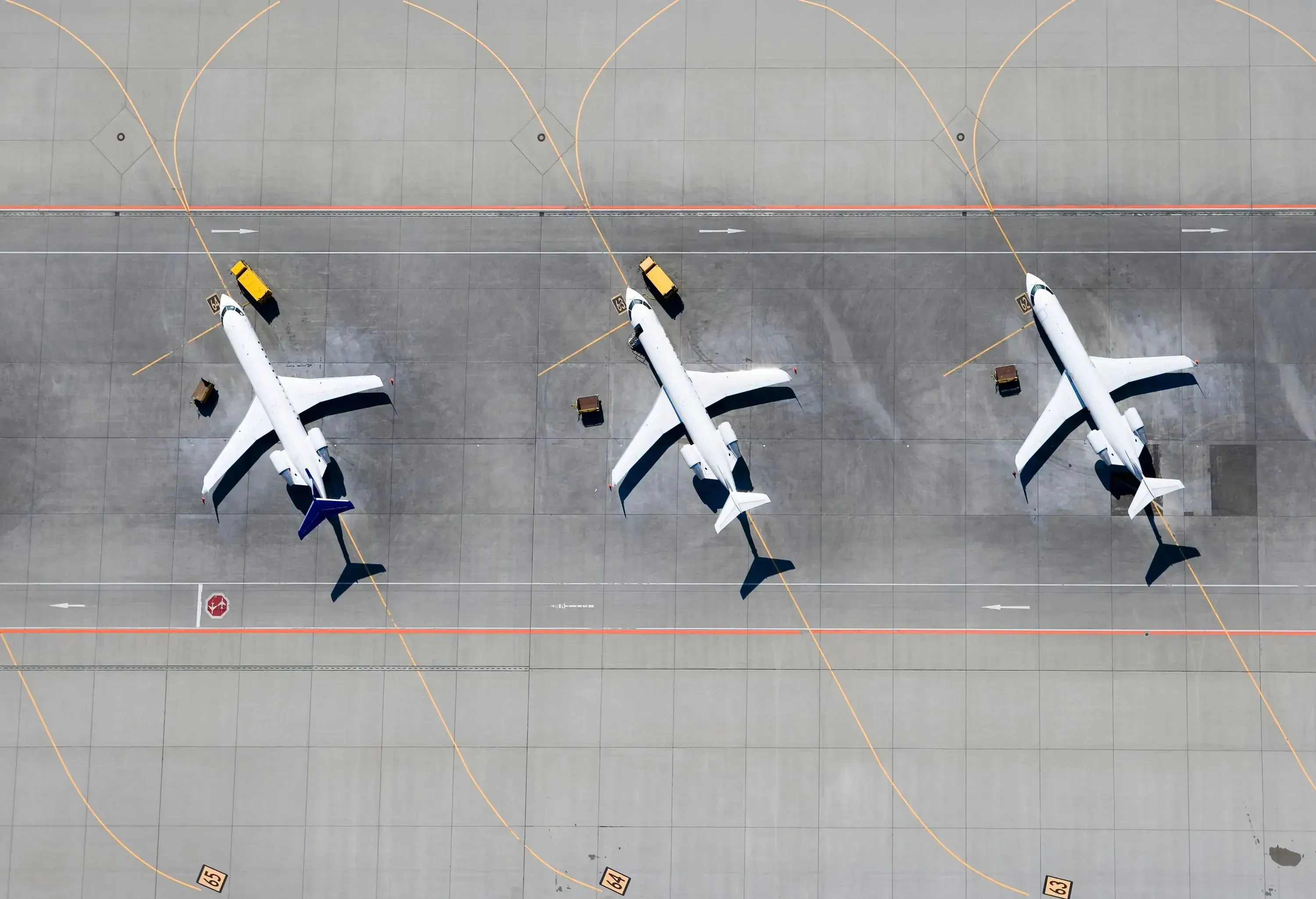 three planes lined up on the runway