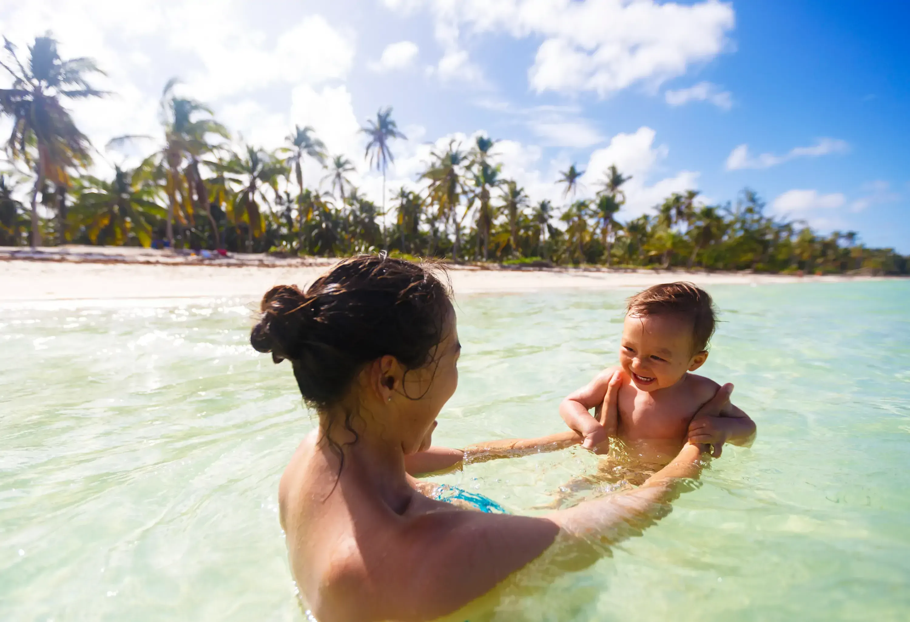 A mother with her son are swimming and playing in a sea