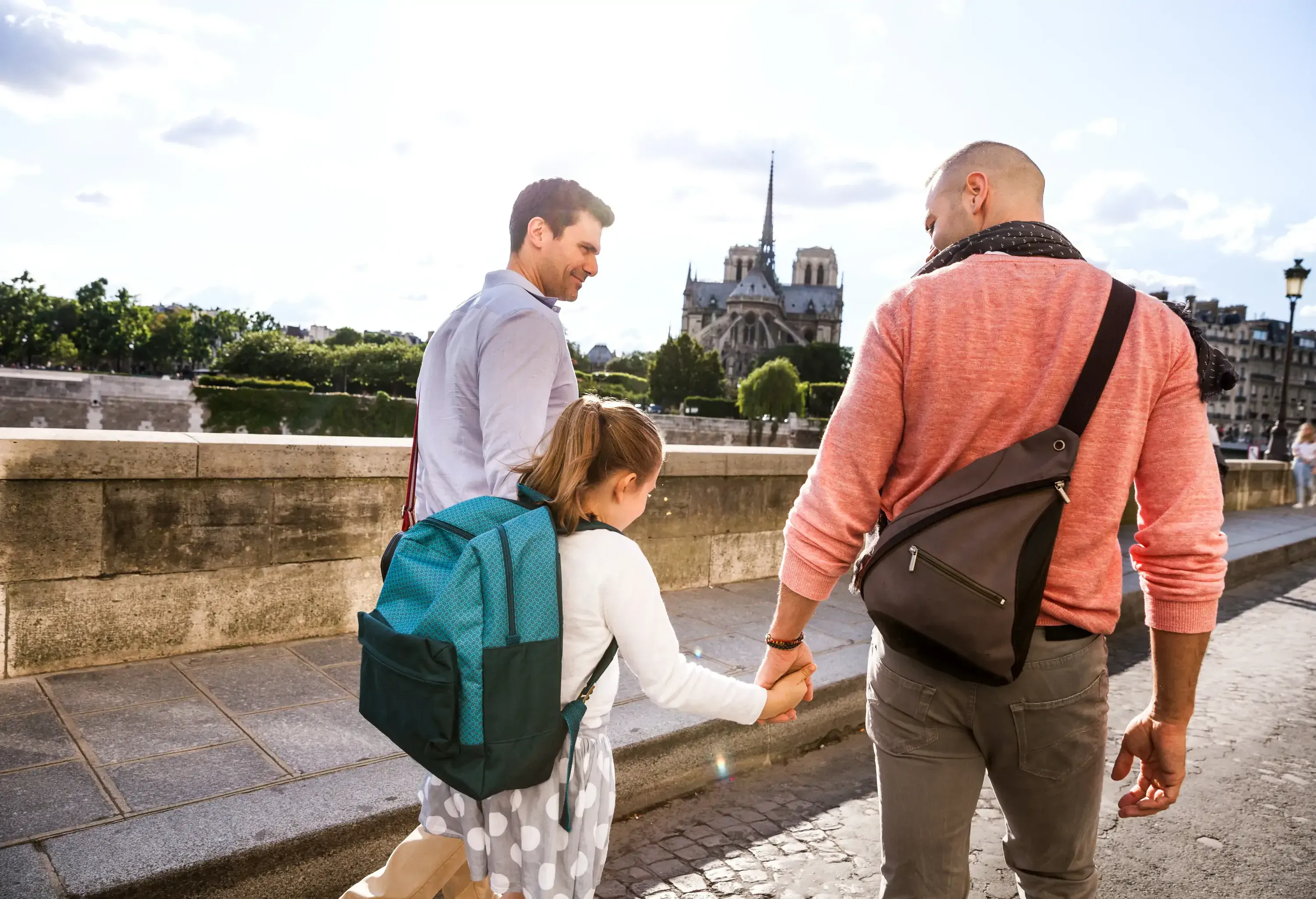 Two day dads with their child in a European city