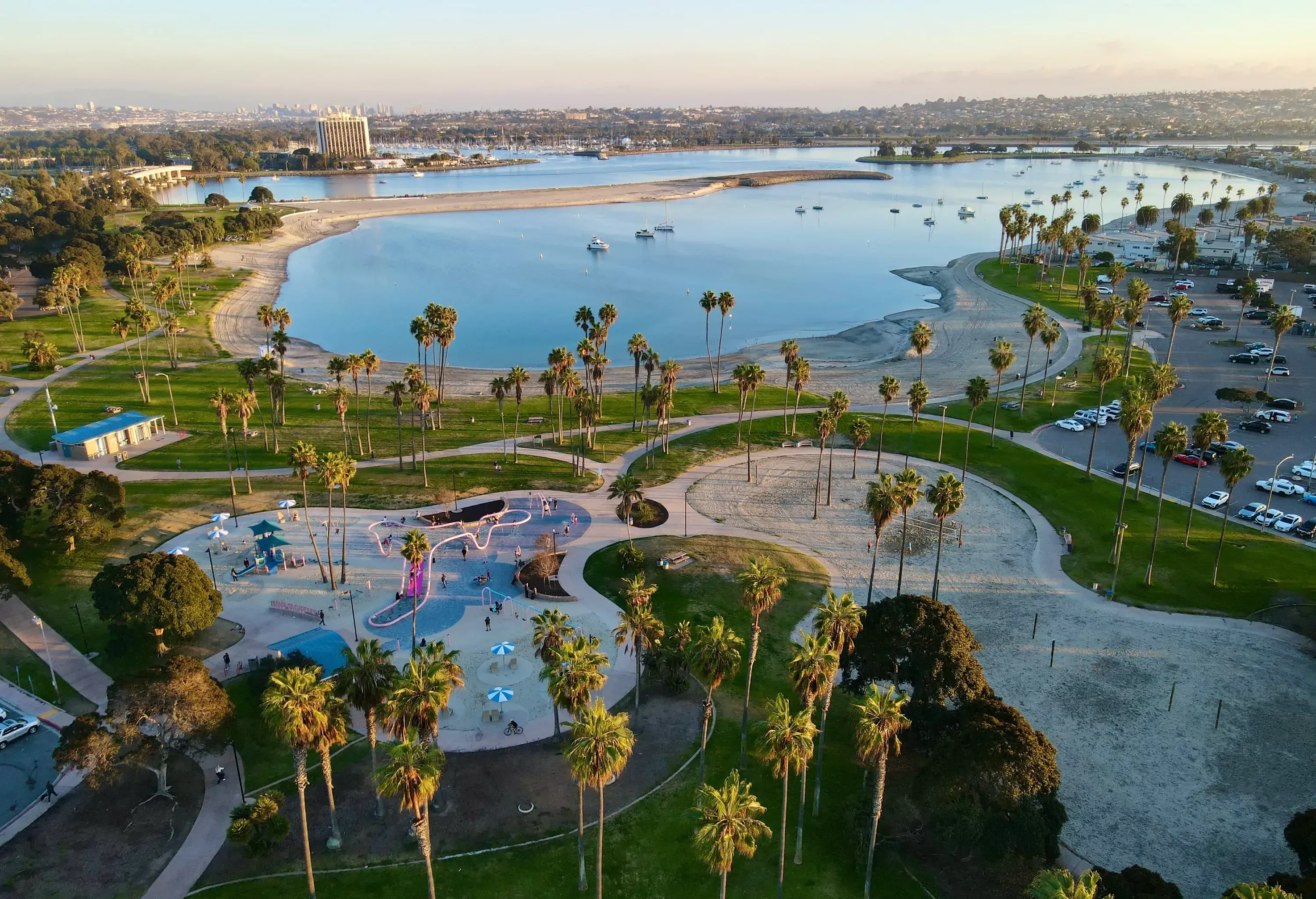 Aerial view from an angle of the Mission Bay and Marina Garden Park at sunset