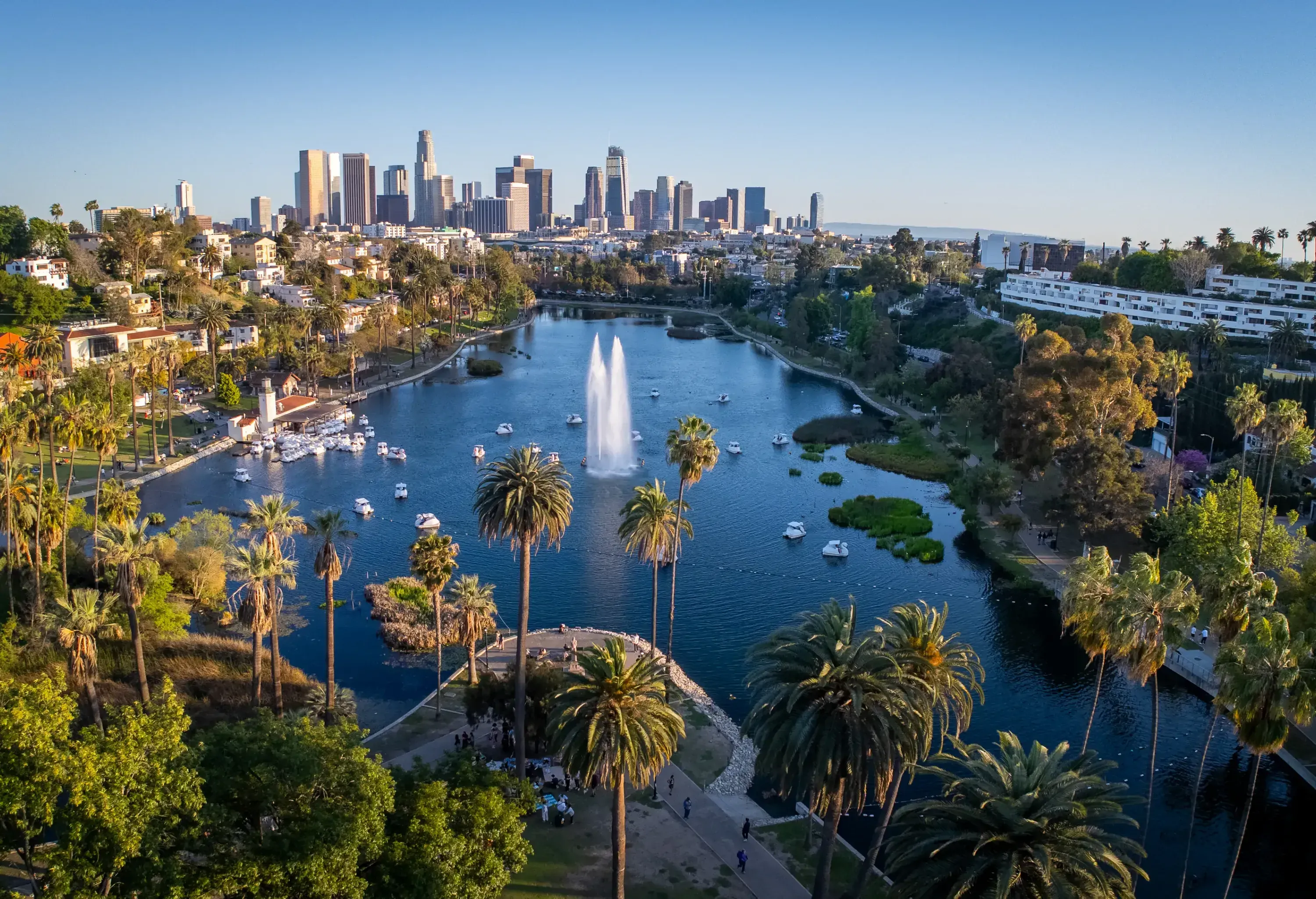 aerial view of city with lake and skyscrapers in the background