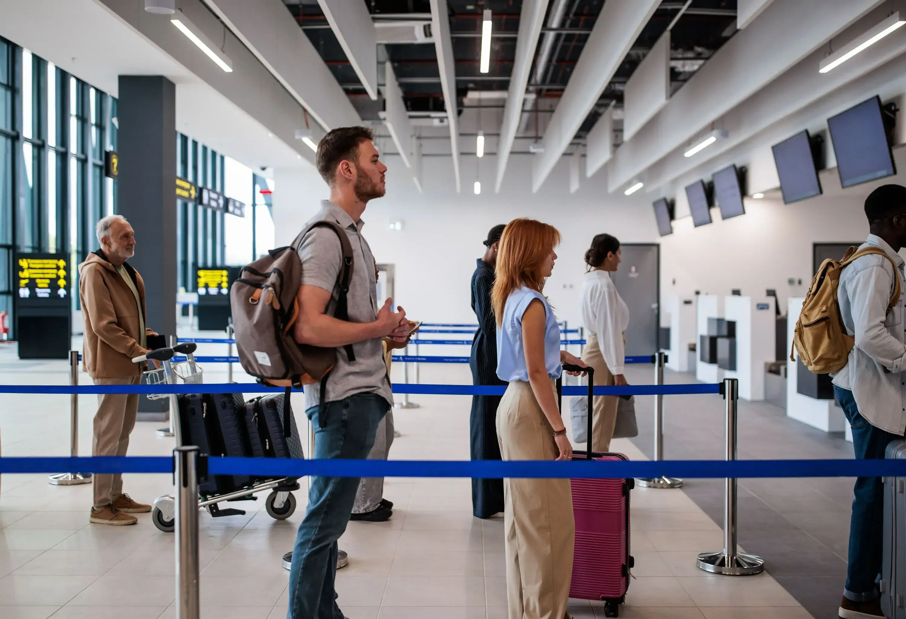 Please standing at the airport and queuing for the check in.