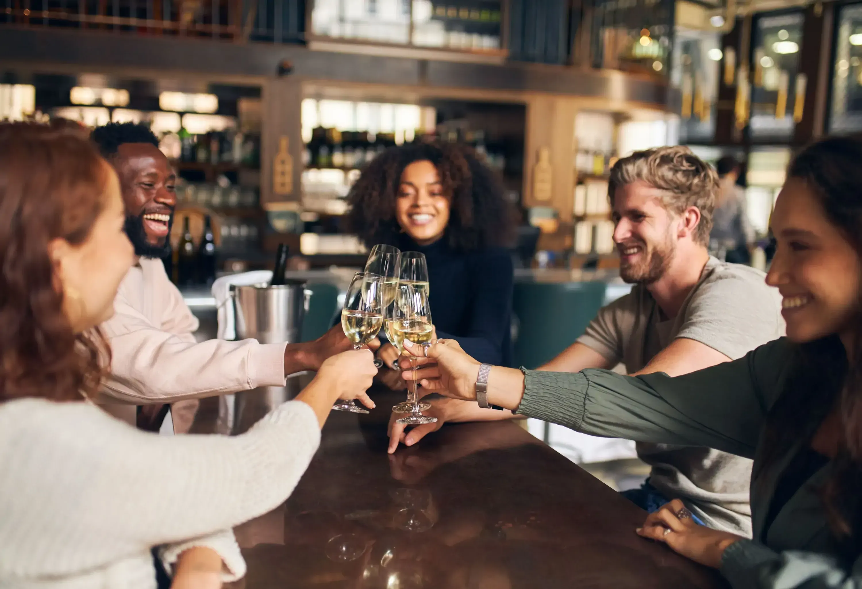 Five friends making a toast with wine glasses.