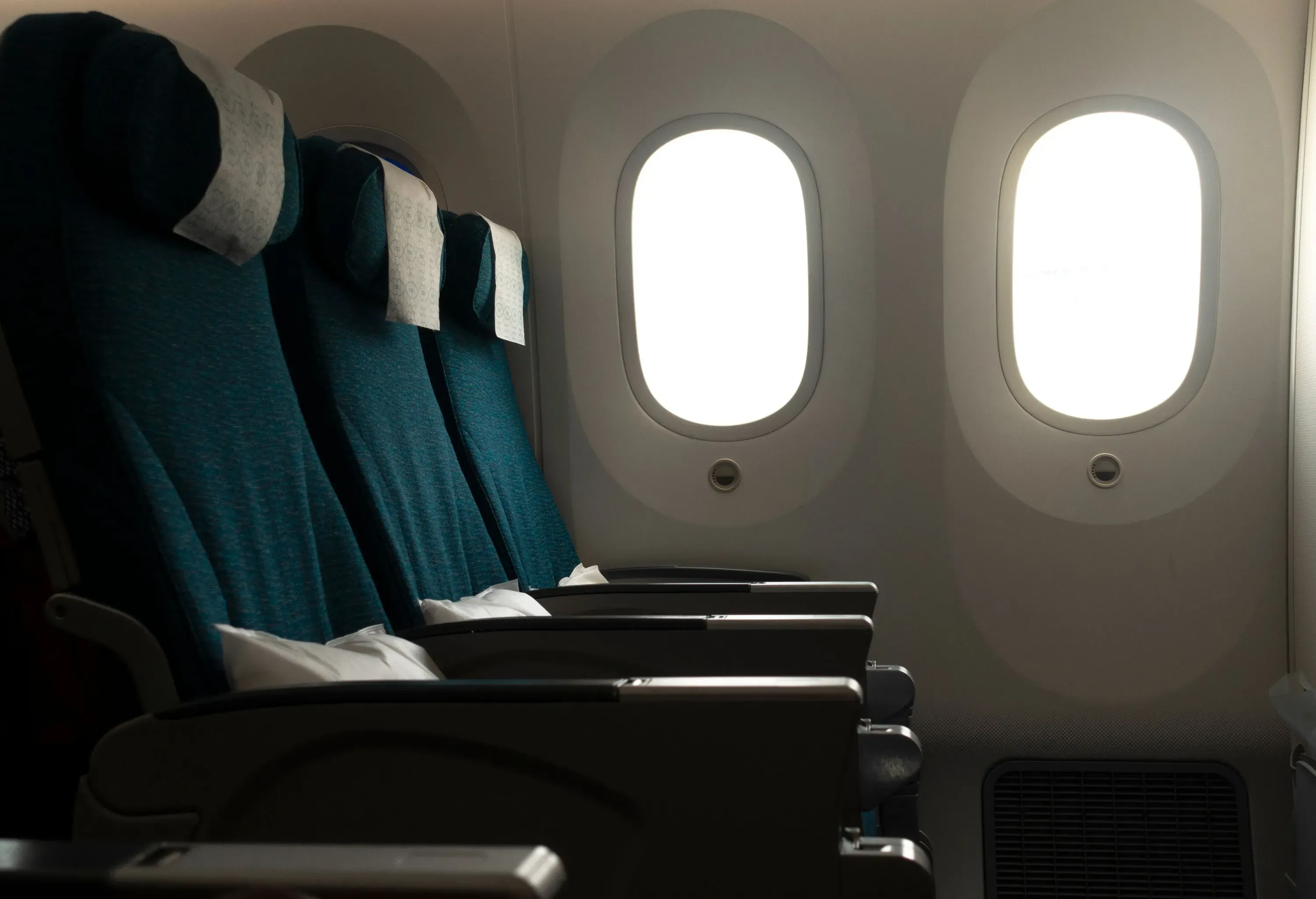 Empty seats inside an aircraft show spacious legroom.