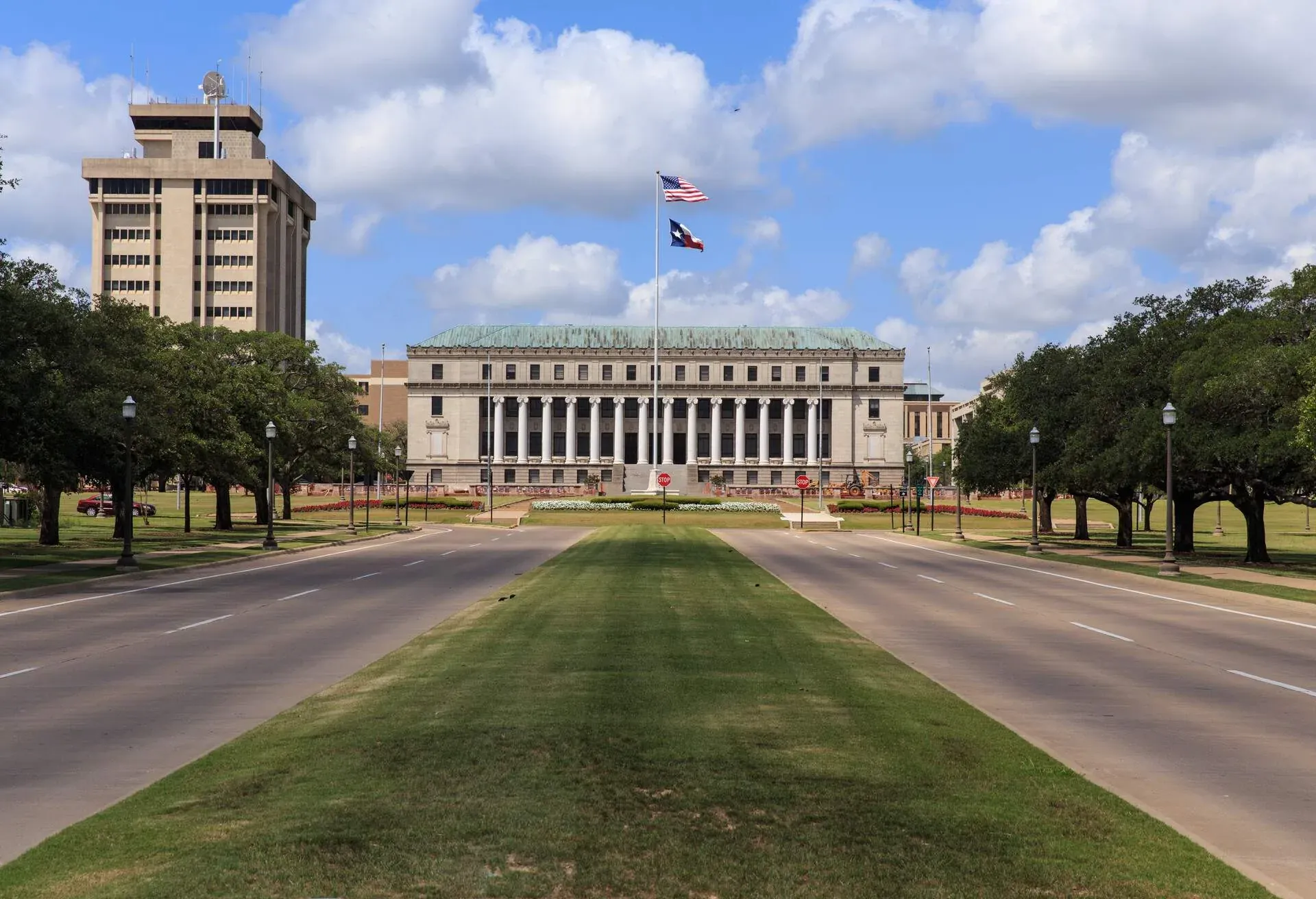 The main entrance to Texas A & M University with the Jack K. Williams Systems Administration building at the end of road in College Station, Texas; Shutterstock ID 1023483109