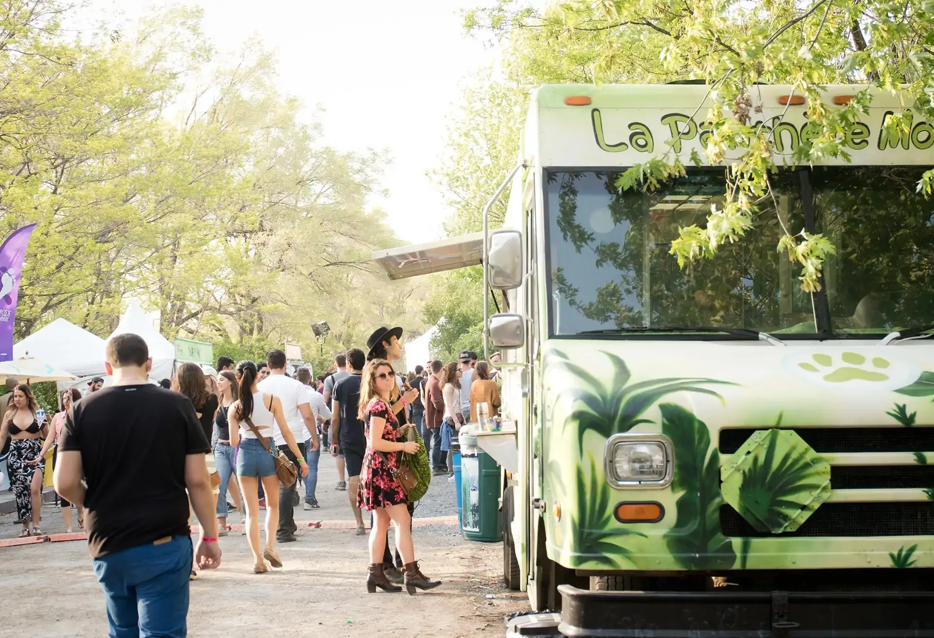 People gathered around a food truck at an outdoor festival