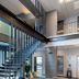 56 Hotel Bangkok lobby with open staircase, glass walls, and mezzanine walkway