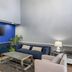 SureStay Plus by Best Western Asheboro lobby lounge with blue accent wall, sofa, chairs, and TV