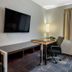 Spark By Hilton Evansville Downtown room with TV, microwave, desk and office chair