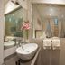 Heritage Hotel Antique Split bathroom with vessel sink, mirror, towels and a view into the bedroom