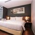 Days Hotel & Suites by Wyndham Fraser Business Park KL room with king bed, window view, and wood flooring in Kuala Lumpur