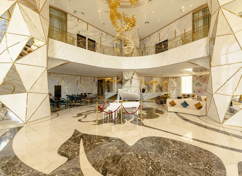 La Vela Saigon Hotel lobby in Ho Chi Minh City with gold geometric columns and chandelier