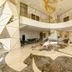 La Vela Saigon Hotel lobby in Ho Chi Minh City with gold geometric columns and chandelier