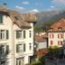 Hotel De La Paix in Interlaken with mountain views and nearby Alpine buildings