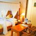 Hotel Deli River and Restaurant Omlandia in Medan, four-poster bed with white canopy and bedside table