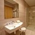 Hotel Sirimiri Bilbao bathroom with sink, mirror, toilet, towel radiator, and glass shower
