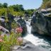 B&B Boutique di Charme Etna-Relax-Natura in Zafferana Etnea: rocky river gorge with waterfall and pink flowers