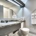 Hotel Marineau Shawinigan bathroom with vanity, toilet, mirror, towels and shower curtain