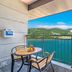 Onda D'oro Hostel in Yeosu balcony with table, chairs and panoramic ocean and hill views