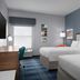 Hampton Inn Russellville guest room with two beds, desk, window and blue carpet