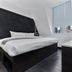 The Z Hotel Holborn in London guest room with king bed, desk, and large window