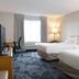 Fairfield Inn & Suites by Marriott Indianapolis East guest room with two beds, window, and lamps