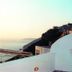 Theoxenia Caldera Hotel, Thera: woman in an outdoor hot tub with caldera and sunset view